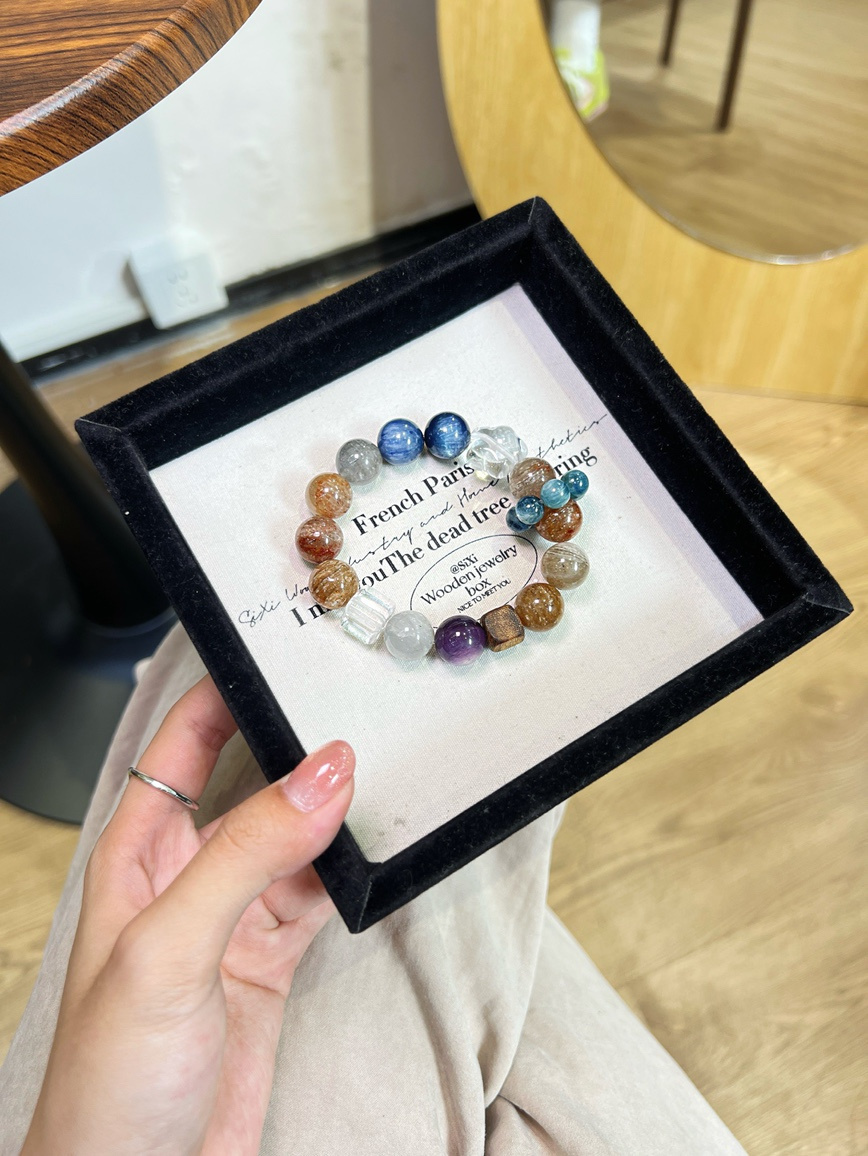 Handmade kyanite and clear quartz bracelet displayed in black jewelry box