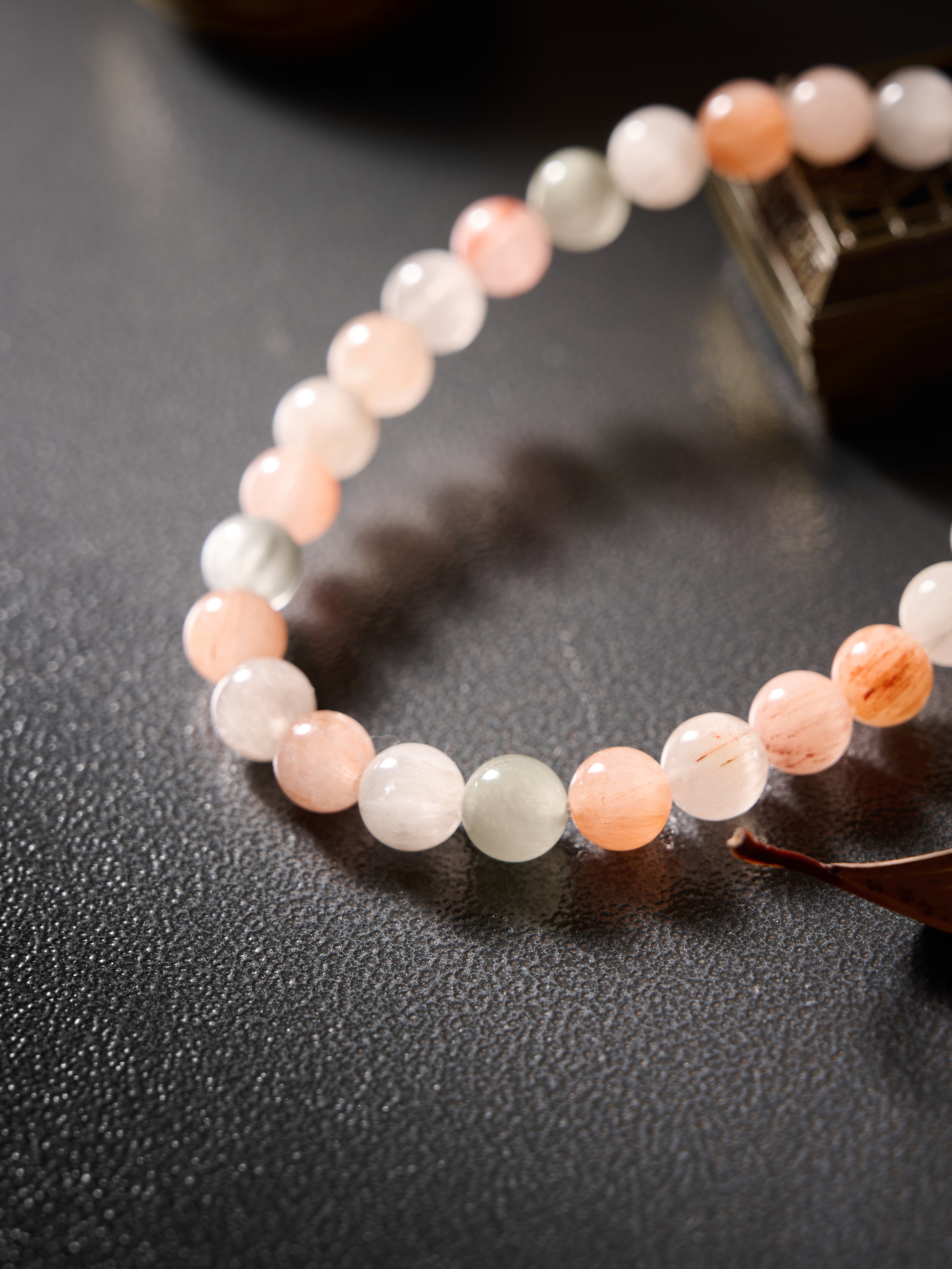 Detail highlight – glossy surface and translucency of natural rutilated quartz beads.