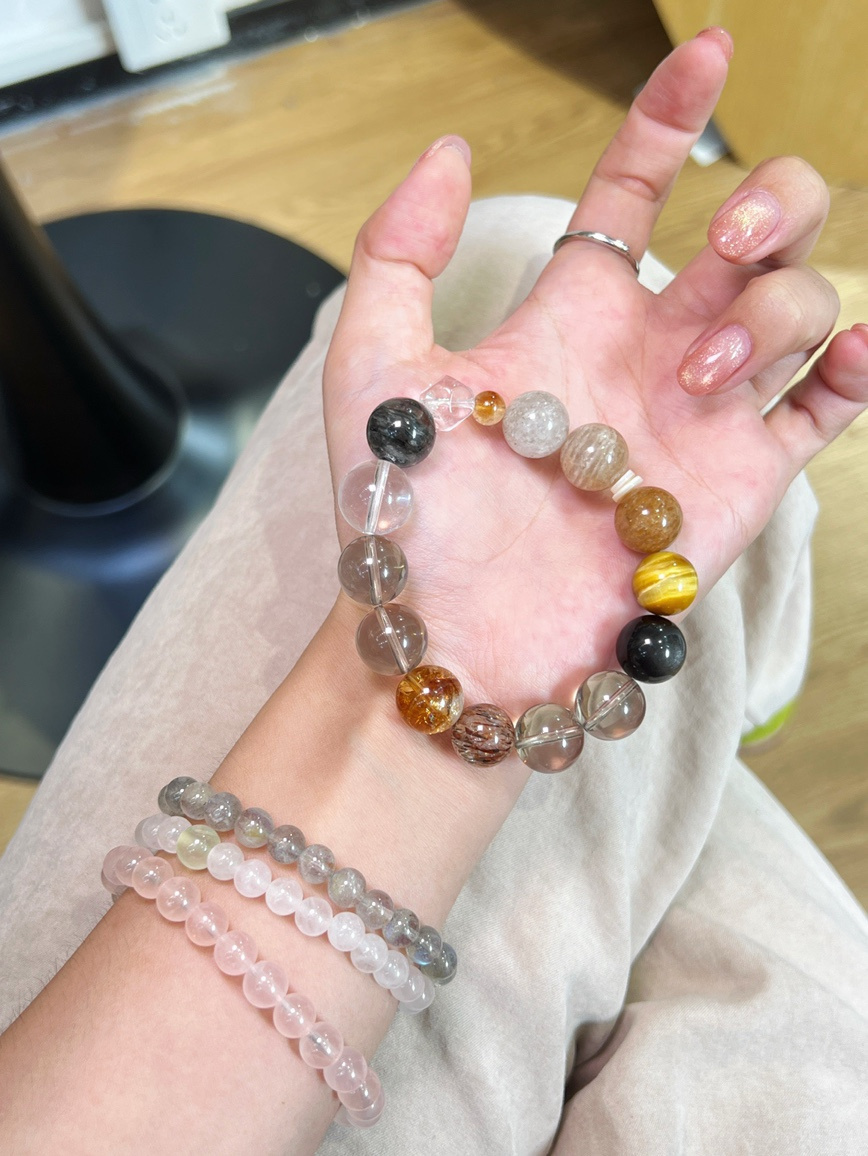 Crystal bracelet shown on hand under warm indoor light