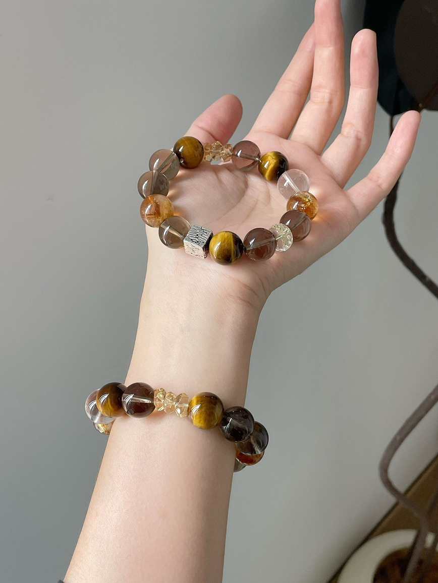 Close-up – golden brown tiger eye beads reflecting natural light.