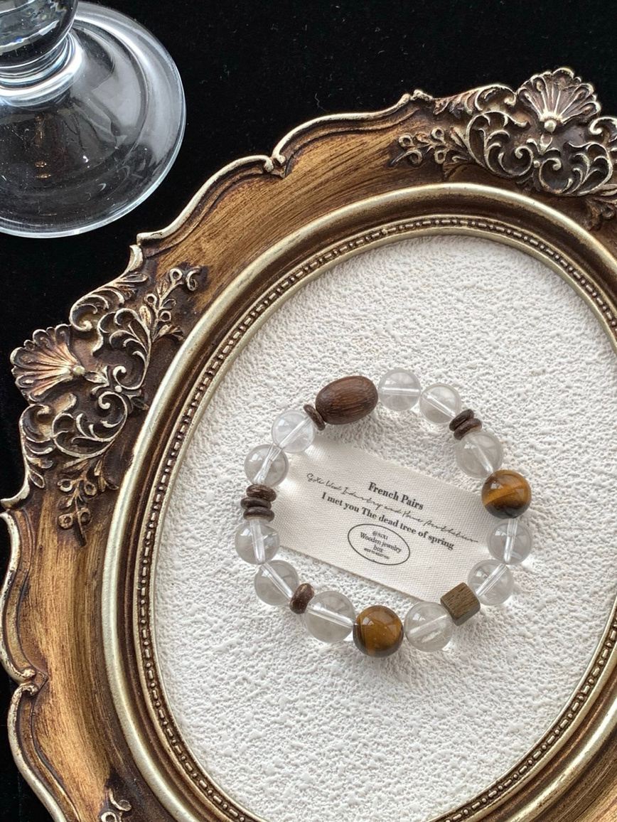 Vintage-style frame showcasing crystal and wood bracelet