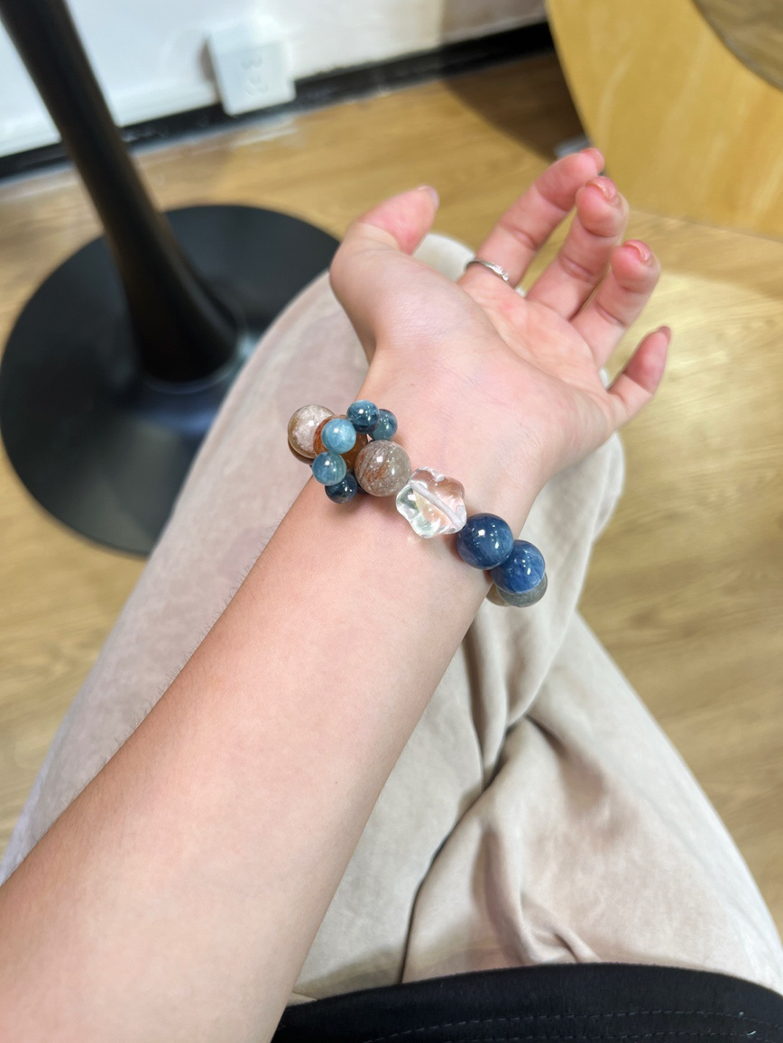 Wrist shot of blue and golden gemstone bracelet for daily wear