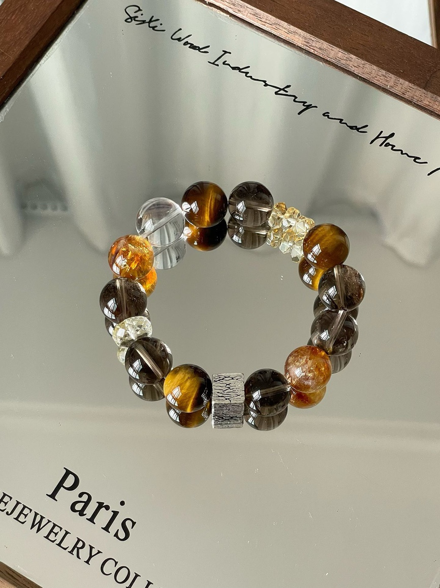 Main view – tiger eye, obsidian, smoky quartz, and clear quartz bracelet on mirror background.