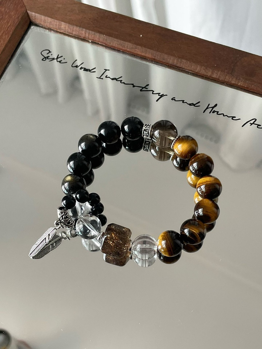 Main view – tiger eye, obsidian, smoky quartz, and clear quartz bracelet on mirror surface.