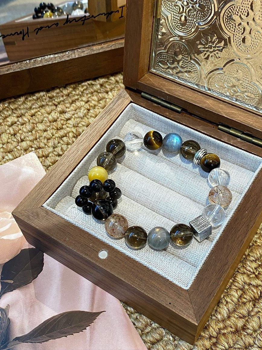 Natural light highlighting the luster of tiger eye and smoky quartz beads.