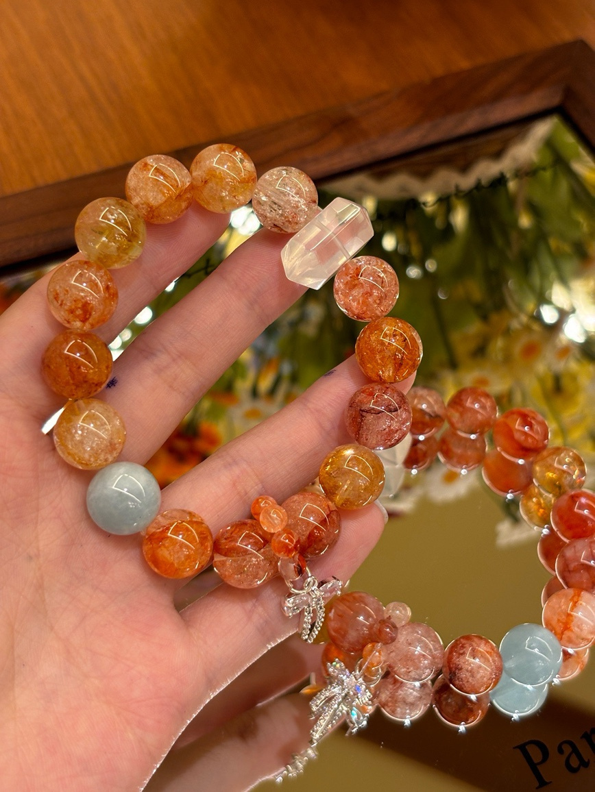 Close-up of red flower crystal bracelet with silver charm