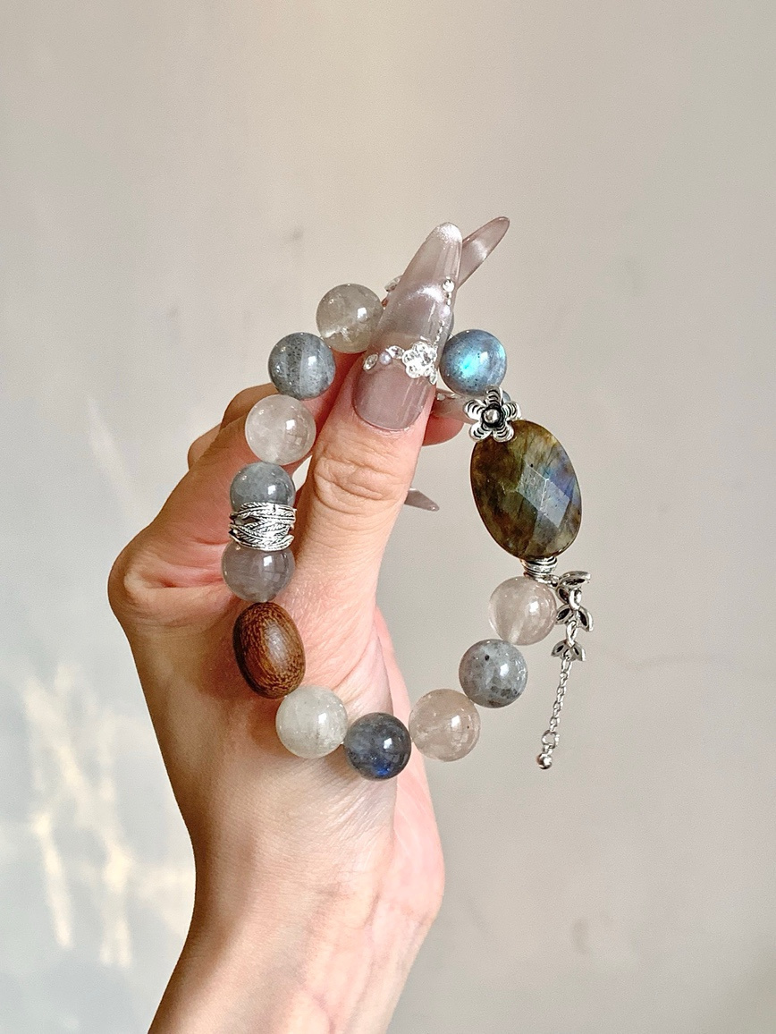 Close-up of gemstone bracelet showing blue flash of Moonstone and wood bead detail