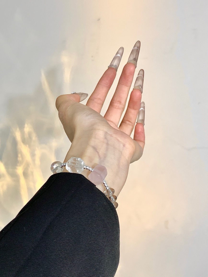 Model wearing the pearl and quartz bracelet under natural light.