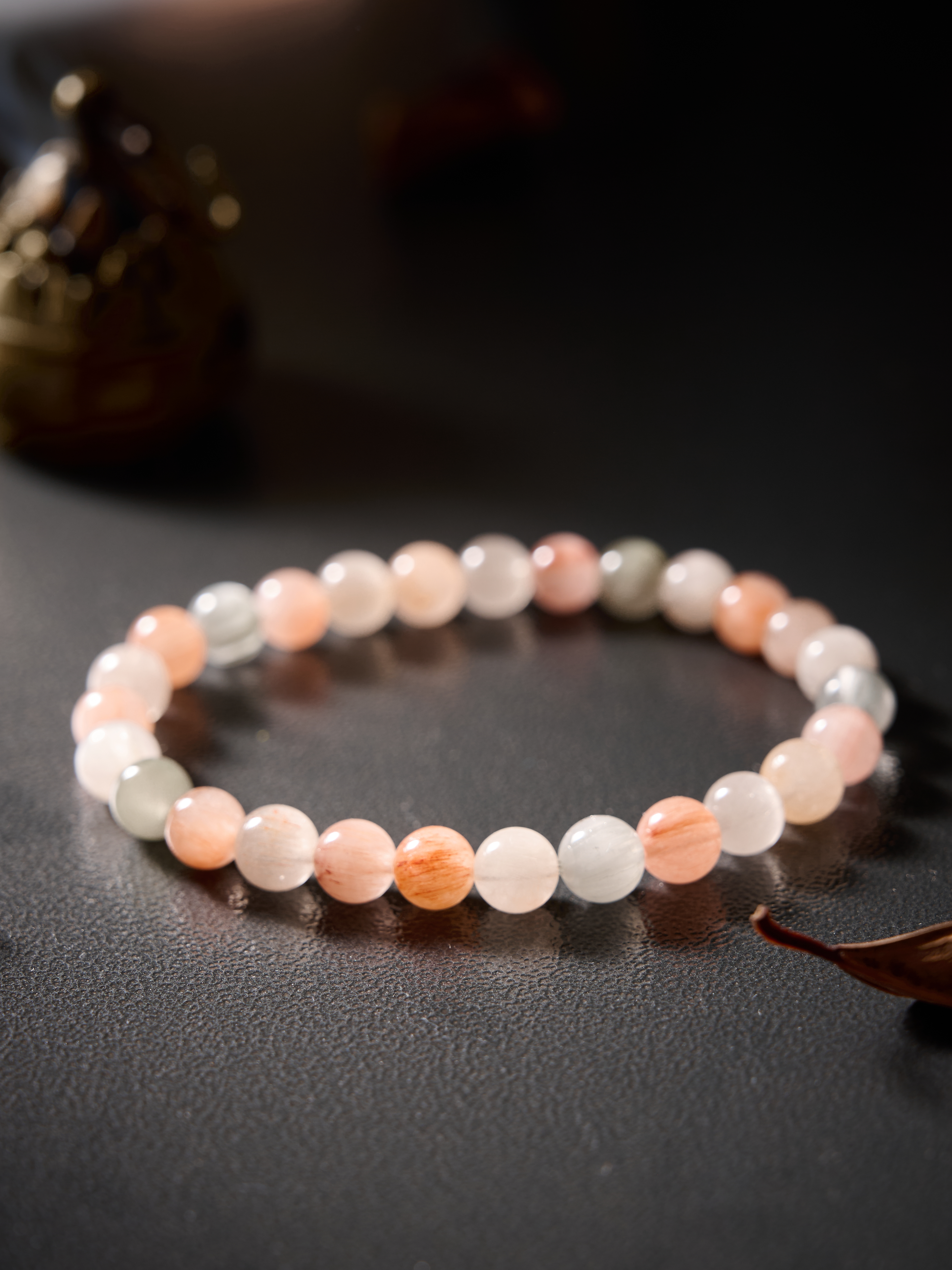 Wrist-on shot – rutilated quartz bracelet worn on hand, clean minimal styling.