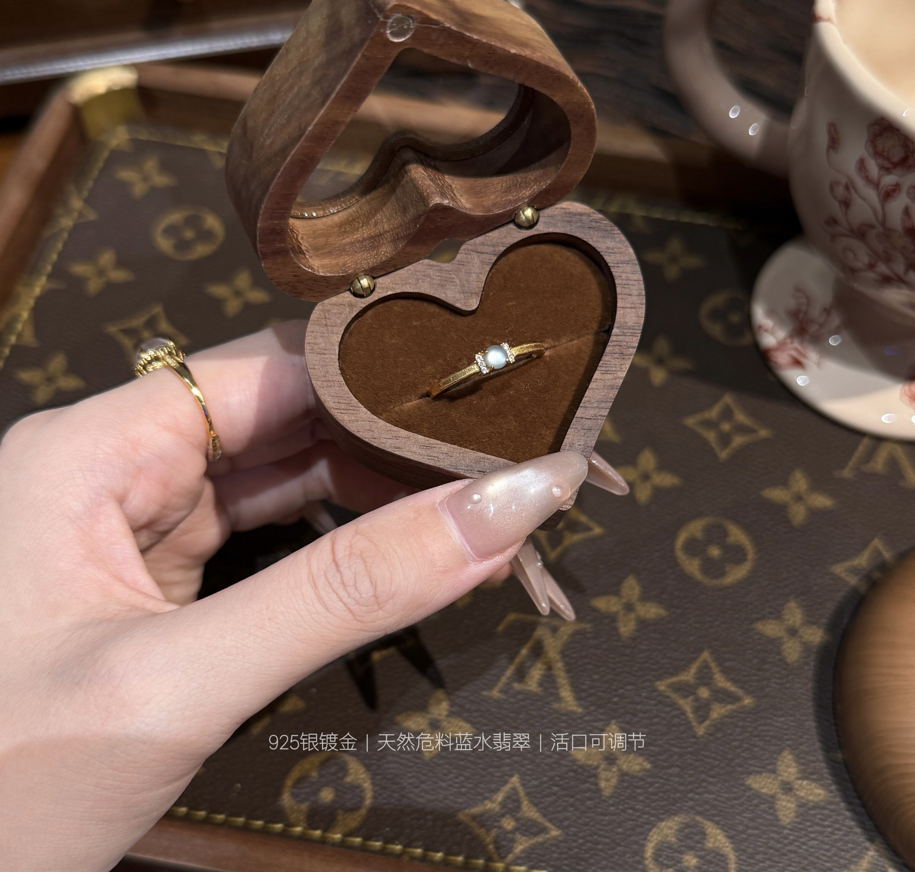 Blue jade ring showcased in luxury wooden jewelry case