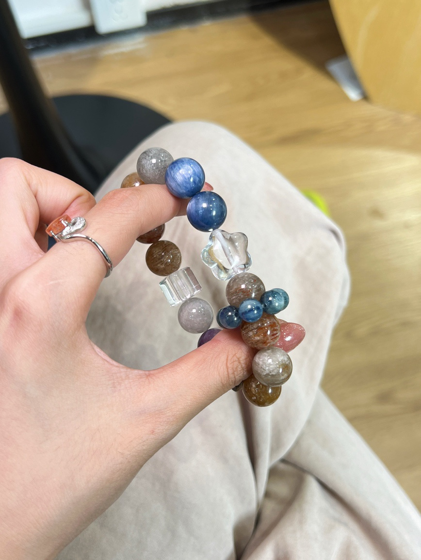 Natural gemstone bracelet featuring kyanite and rabbit hair quartz in soft lighting