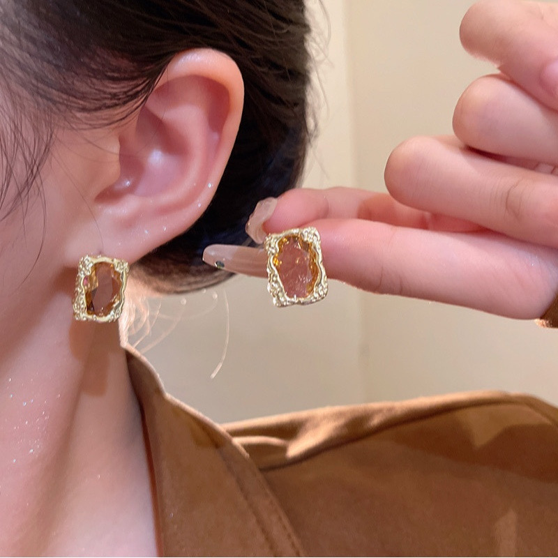 Gold rhinestone rectangular earrings worn and handheld E6818