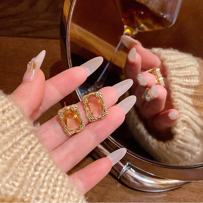 Gold rectangular stud earrings mirror lifestyle display E6818