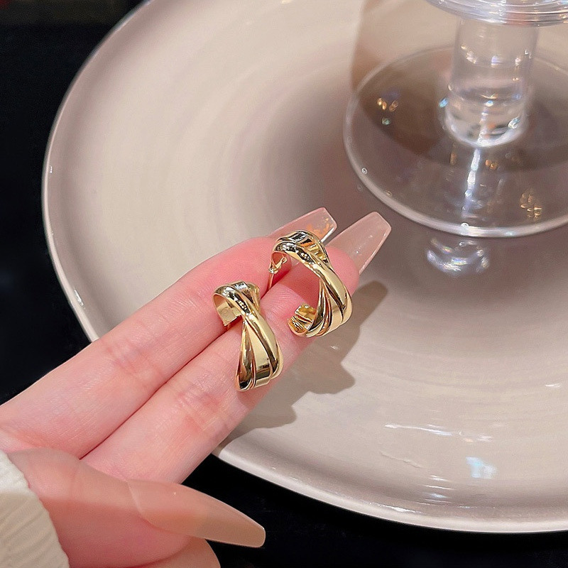  Gold twisted hoop earrings pair close-up