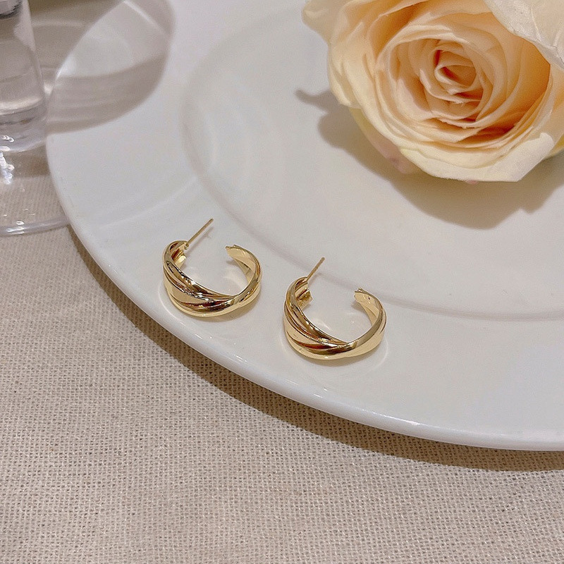  Gold twisted hoop earrings styled with rose