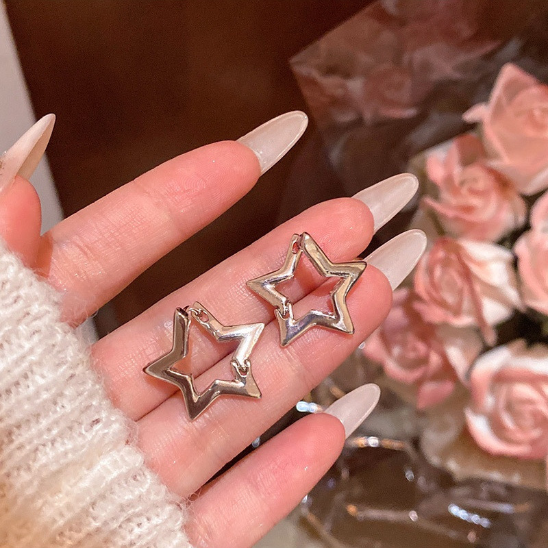 Silver statement star hoop earrings with floral background