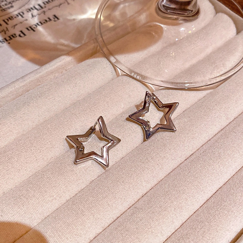 Silver open star earrings product display