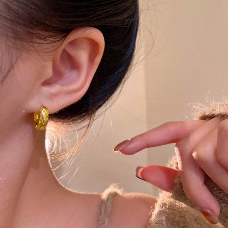 Gold chunky textured hoop earrings close-up
