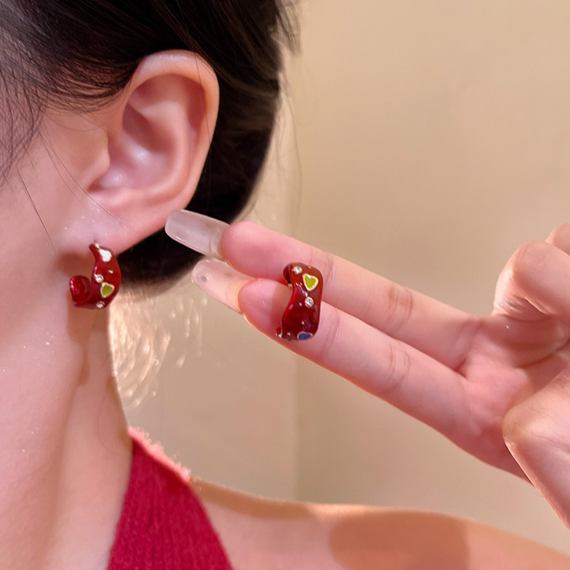 Red rhinestone heart hoop earrings close-up