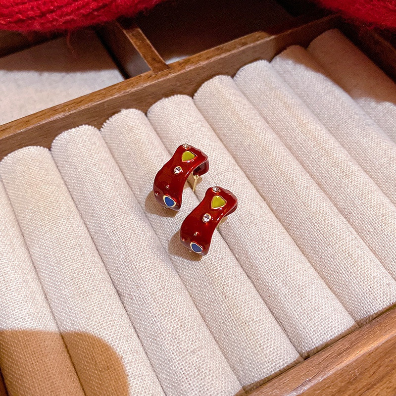 Red heart hoop earrings displayed in jewelry tray