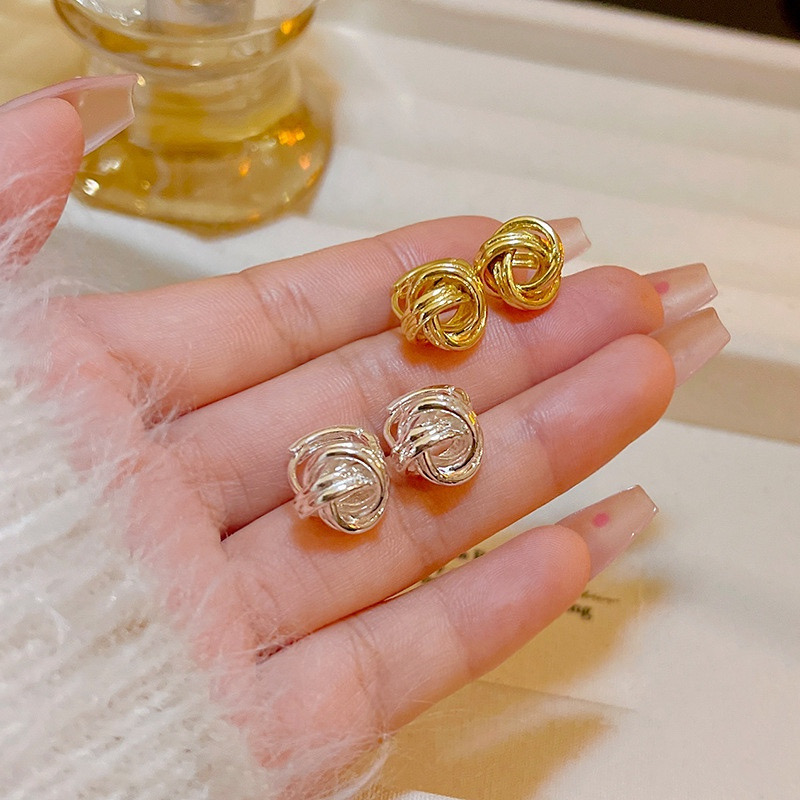 Gold and silver intertwined knot stud earrings