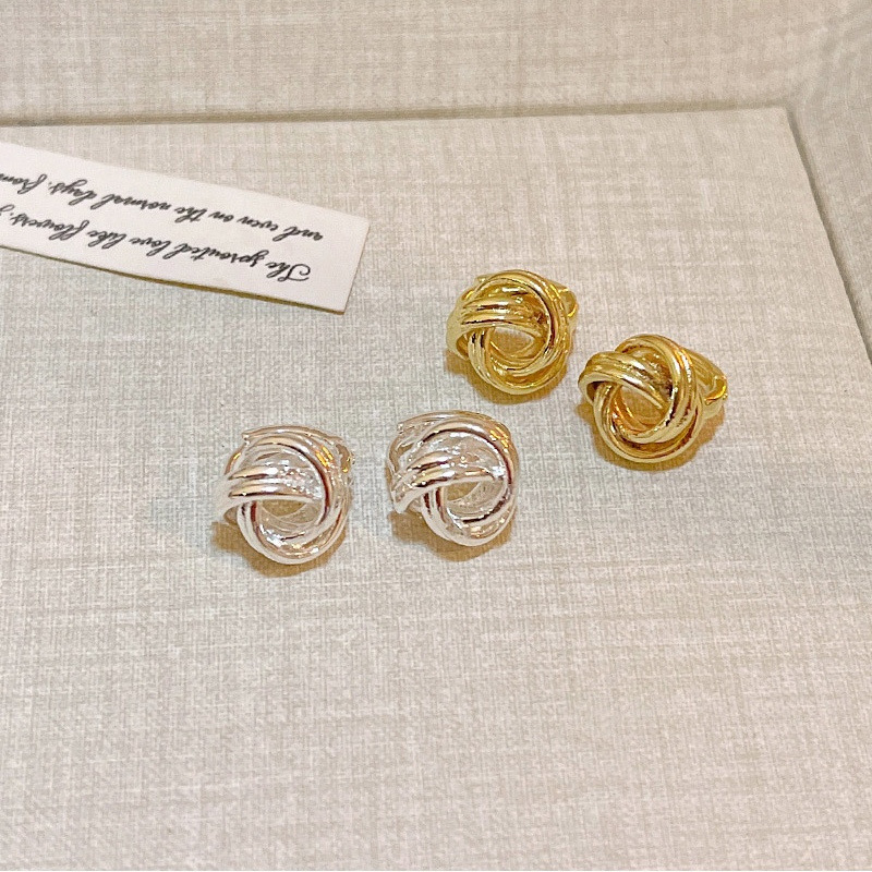 Gold and silver knot stud earrings display