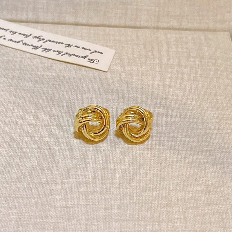 Gold knot stud earrings close-up