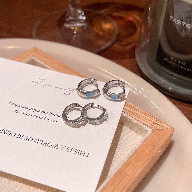 Silver blue butterfly earrings close-up display