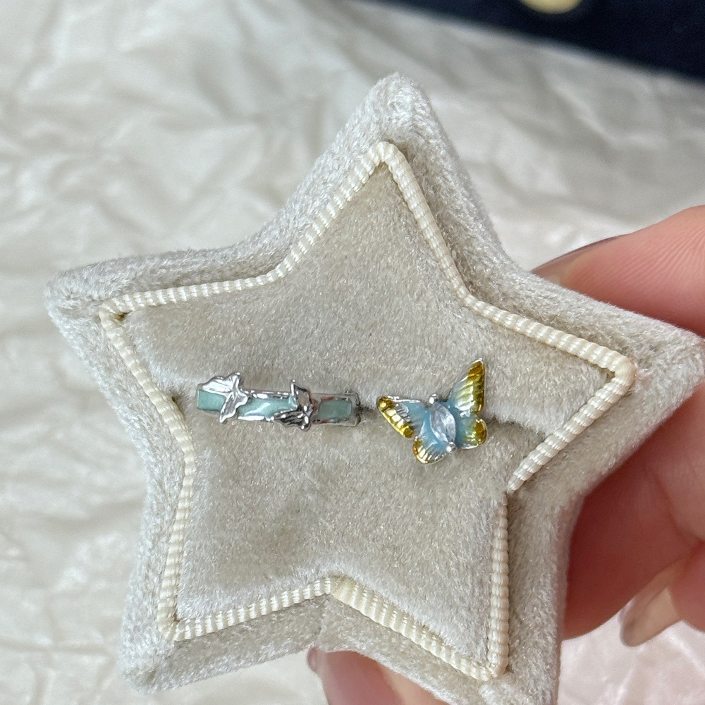 Silver blue butterfly huggie earrings detail view