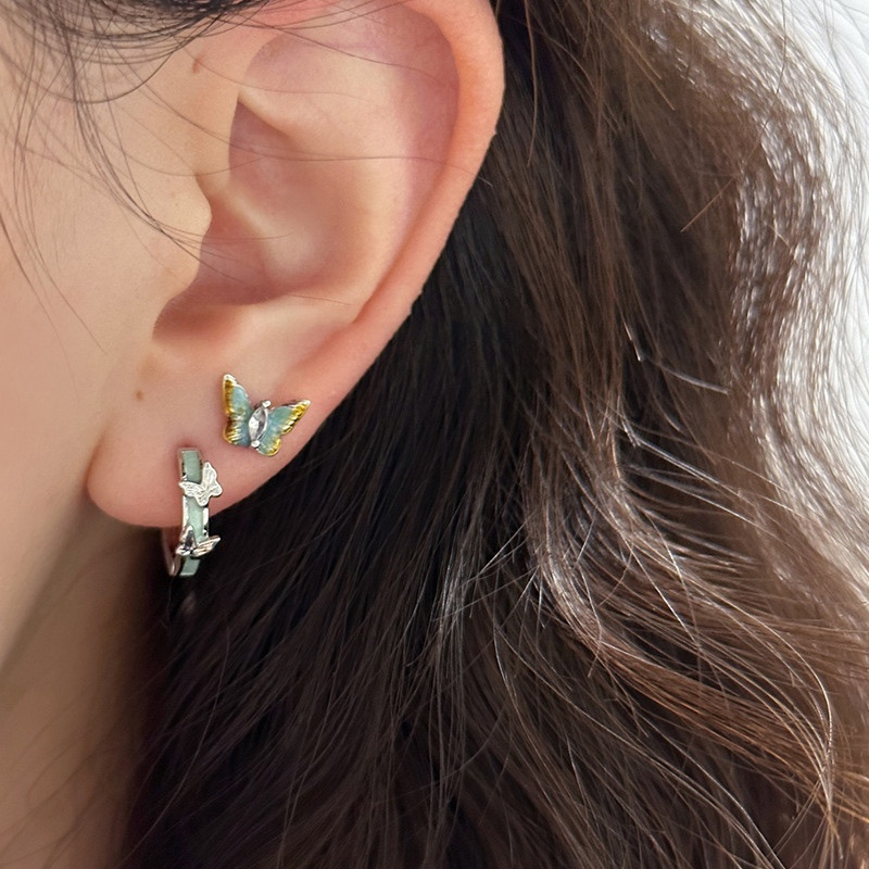 Blue butterfly hoop earrings styling on ear