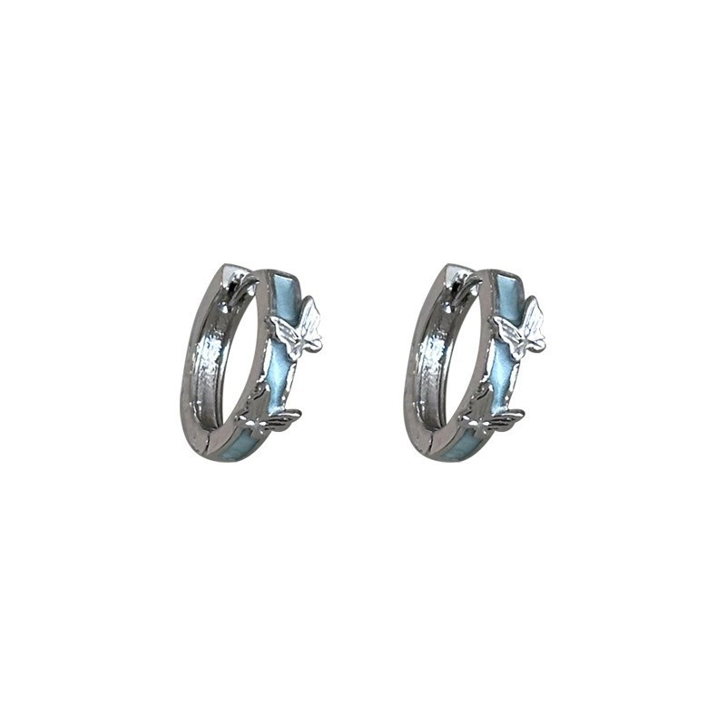 Silver blue butterfly hoop earrings on white background