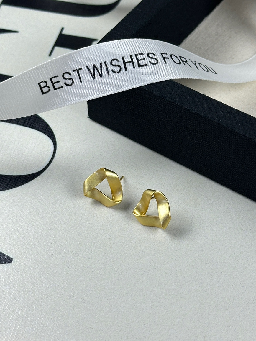Gold sculptural earrings lifestyle display