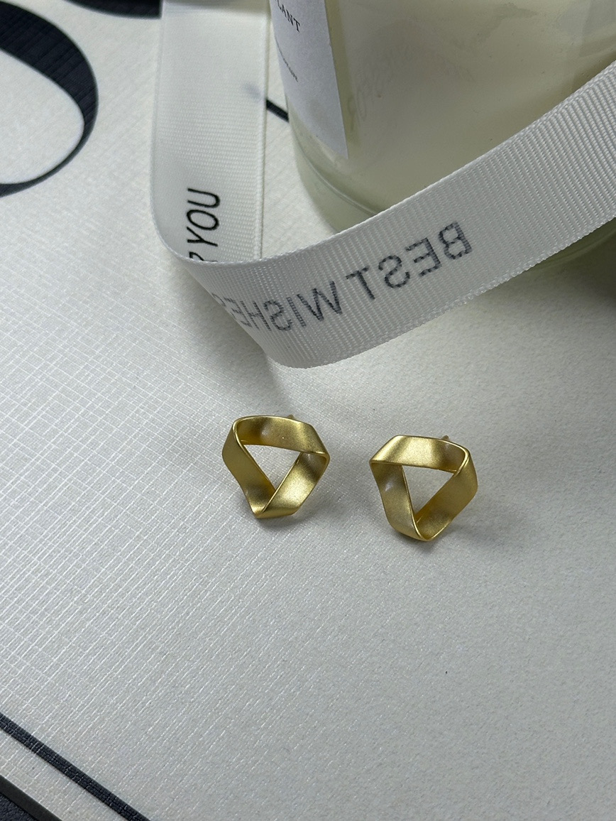 Gold twisted earrings close-up view