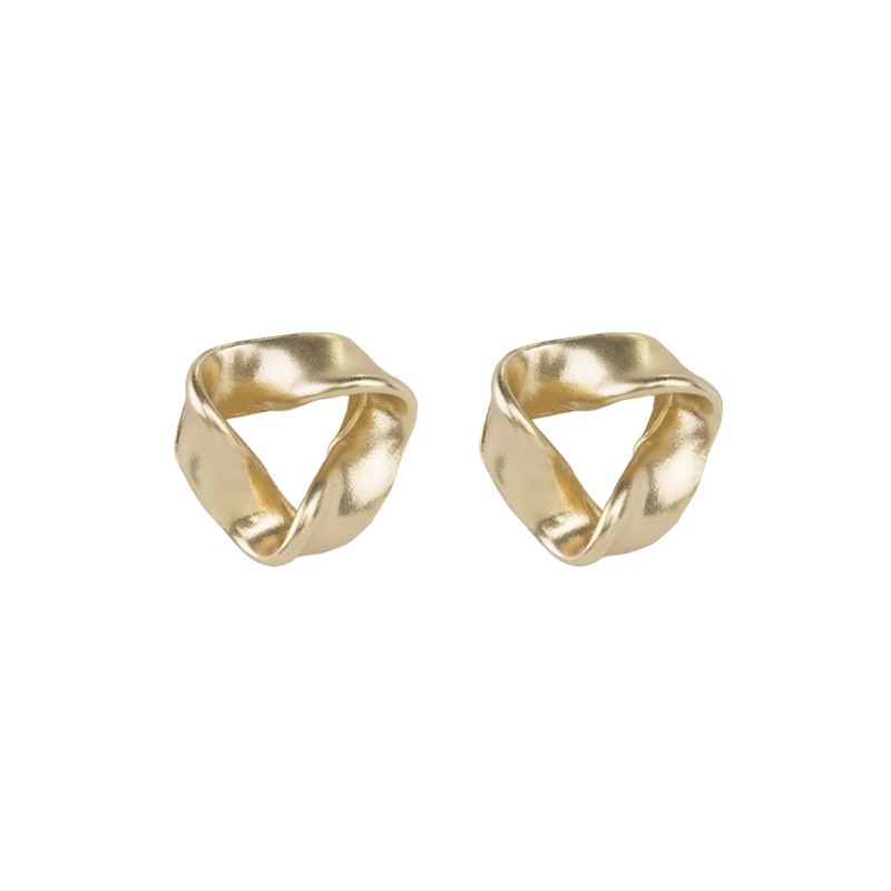 Gold twisted geometric earrings on white background