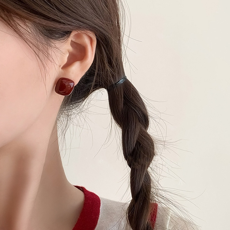 Burgundy square enamel stud earrings worn by model