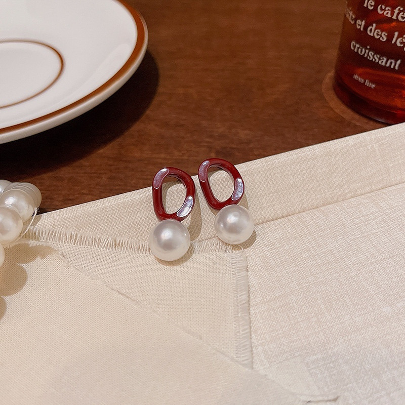 Burgundy faux pearl drop earrings display