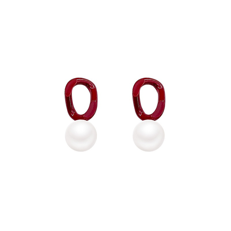 Burgundy pearl drop earrings on white background