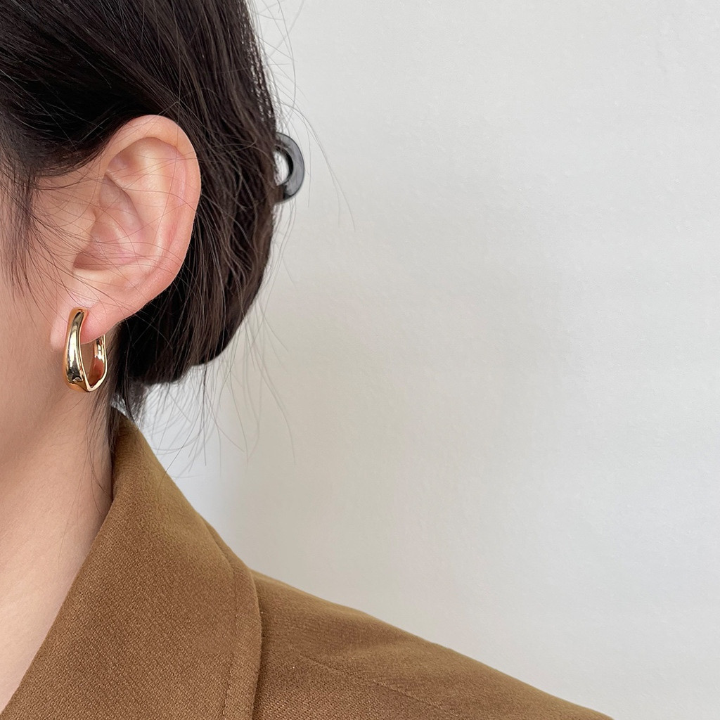 Gold Chunky Hoop Earrings on Ear