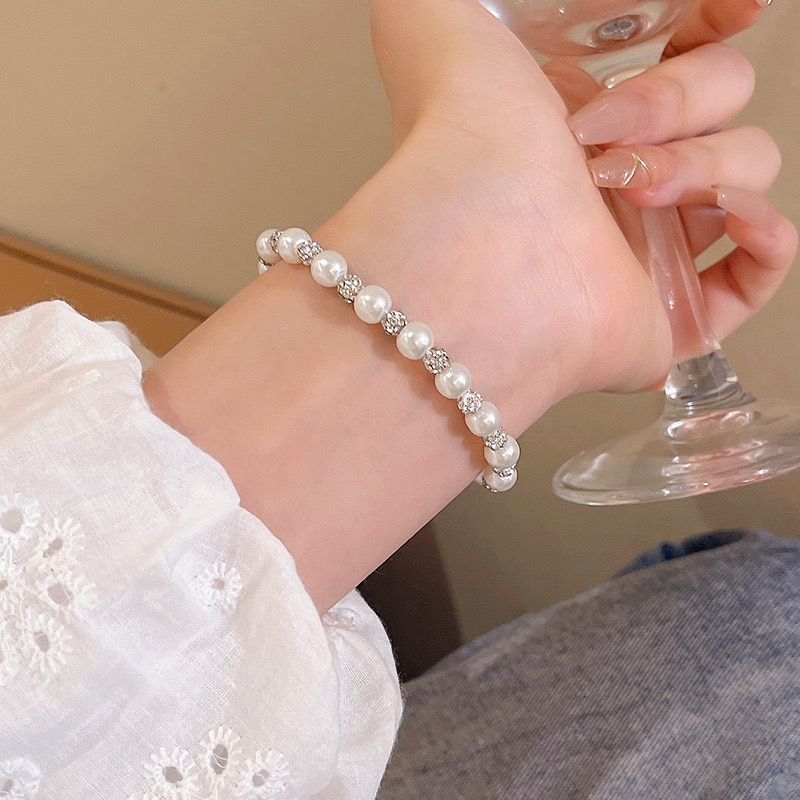 White Faux Pearl and Sparkle Bracelet Worn on Wrist