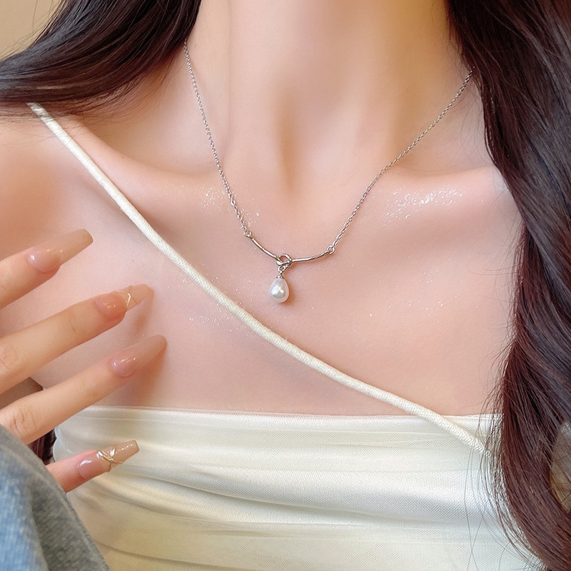 Silver Teardrop Faux Pearl Pendant Necklace Worn with White Top