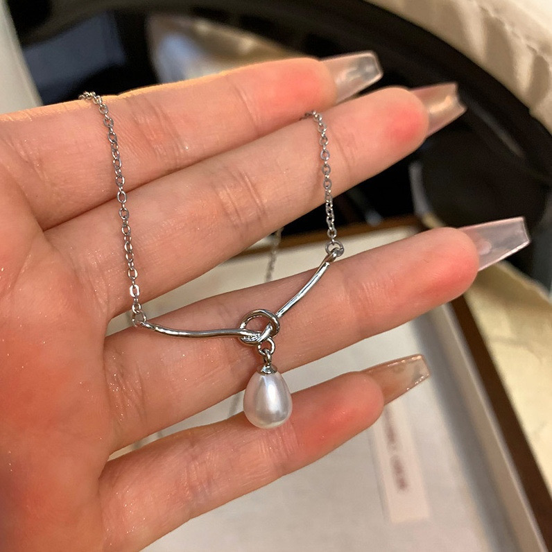Detail View of Silver Curved Bar and Faux Pearl Drop Necklace