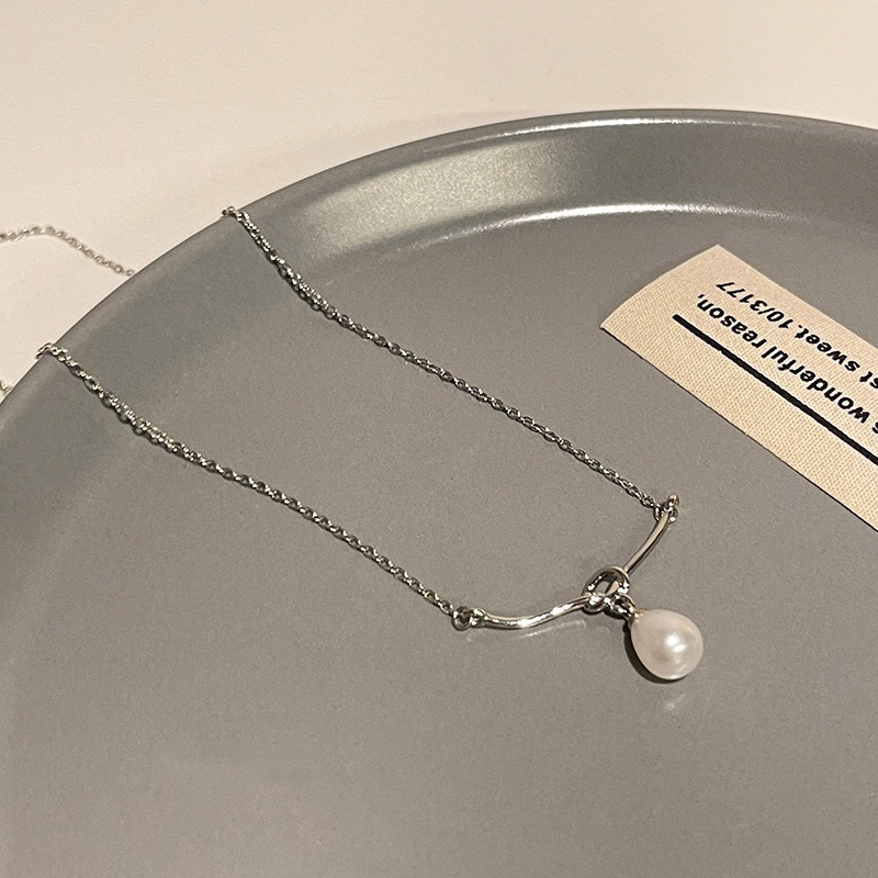 Silver Teardrop Faux Pearl Pendant Necklace Flat Lay on Gray Tray