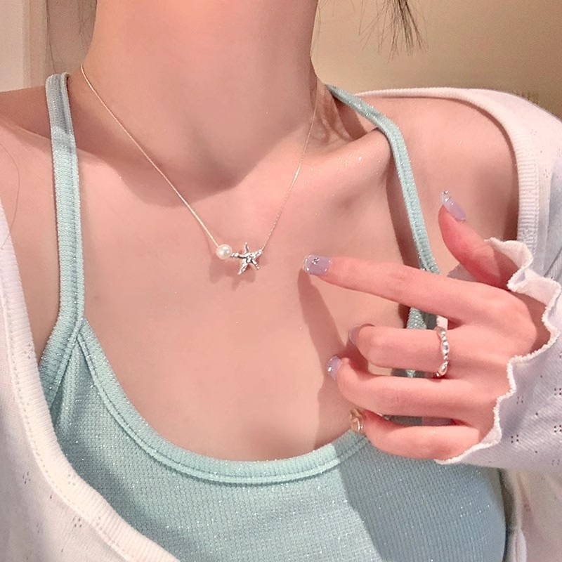 Silver Starfish Necklace with White Faux Pearl Worn with Light Green Top
