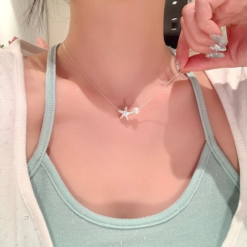 Minimalist Silver Starfish Necklace with Faux Pearl Accent on Model