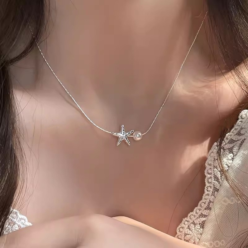 Silver Starfish Faux Pearl Pendant Necklace Worn with White Lace Outfit