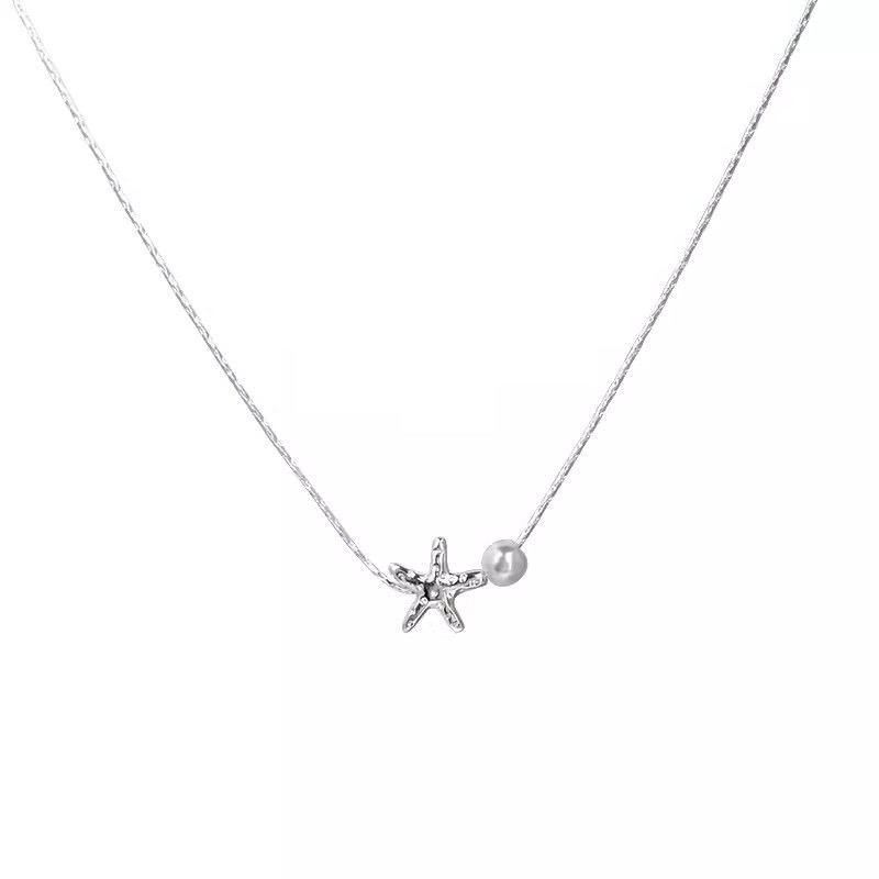 Silver Starfish Pendant Necklace with White Faux Pearl Accent on White Background