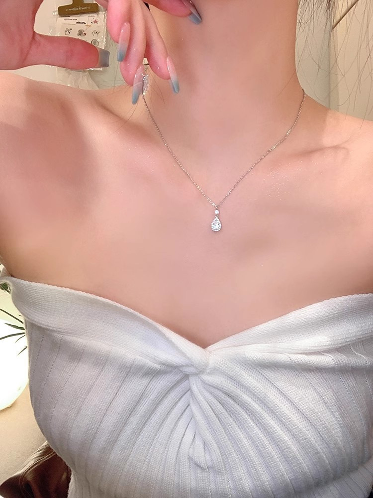 Silver teardrop zircon pendant necklace styled with a white off-shoulder outfit