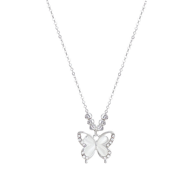 Silver cat eye butterfly pendant necklace with white butterfly wings, rhinestone accents and delicate silver-tone chain on white background