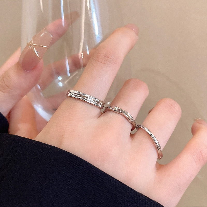 Three Silver Textured Open Rings on Fingers