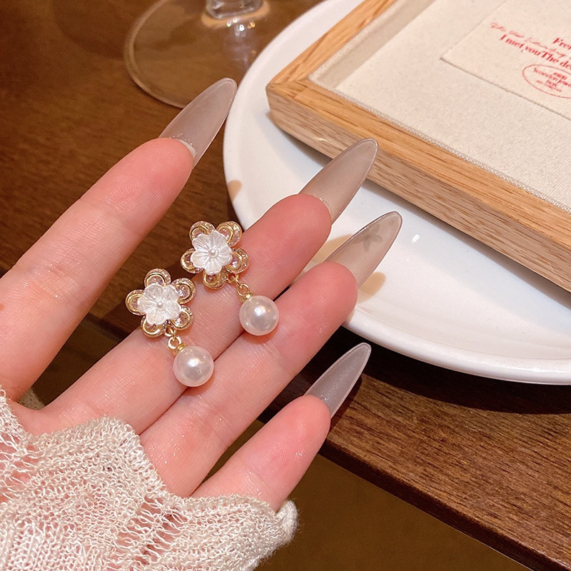 Gold pearl drop earrings with white flower design